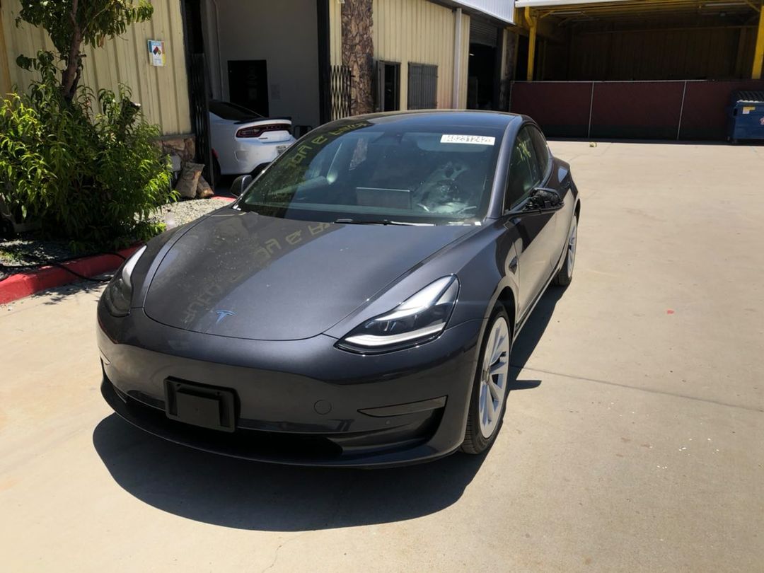 Gray Tesla Model 3 with a flawless finish outside the shop
